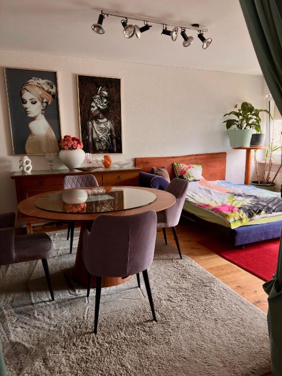 a living room with a table and a bed at Royal Apartment 02 in Schaan