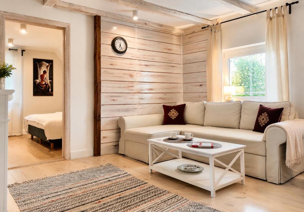 a living room with a couch and a table at Apartamenty Turystyczne WillkasSen in Giżycko