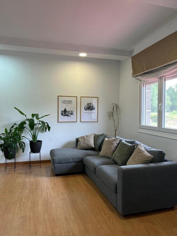 a living room with a couch and a window at Casa Xoubiña in Mos