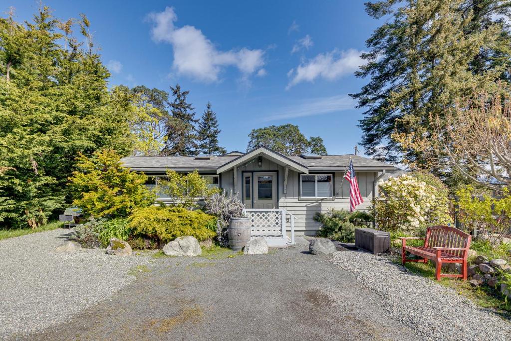a house with a flag in front of it at Walkable, Dog Friendly! Friday Harbor Stay w/ Deck in Friday Harbor