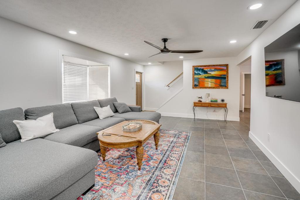 a living room with a couch and a table at Deck + Pool Table! Walk to Dtwn Jensen Beach in Jensen Beach