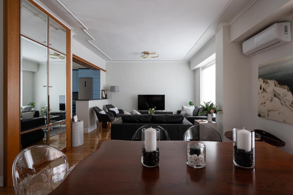 a living room with a table and a couch at Oly modern apartment in Katerini
