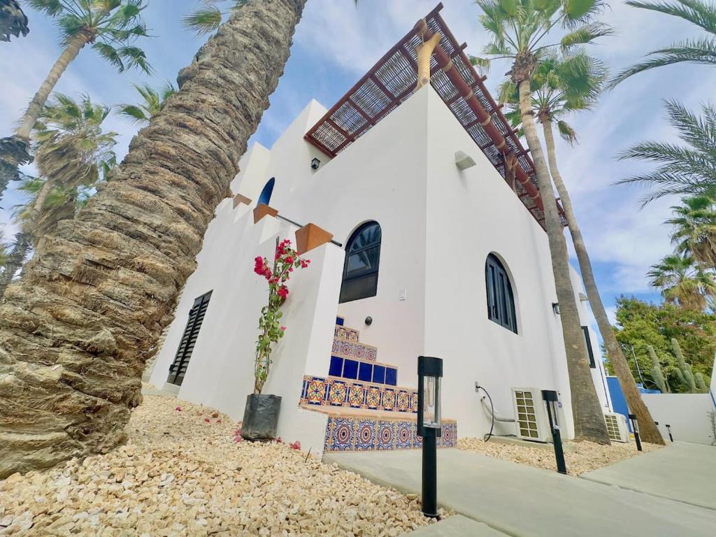 a church with a palm tree in front of it at Near Beach Casita With Firepit in Los Barriles