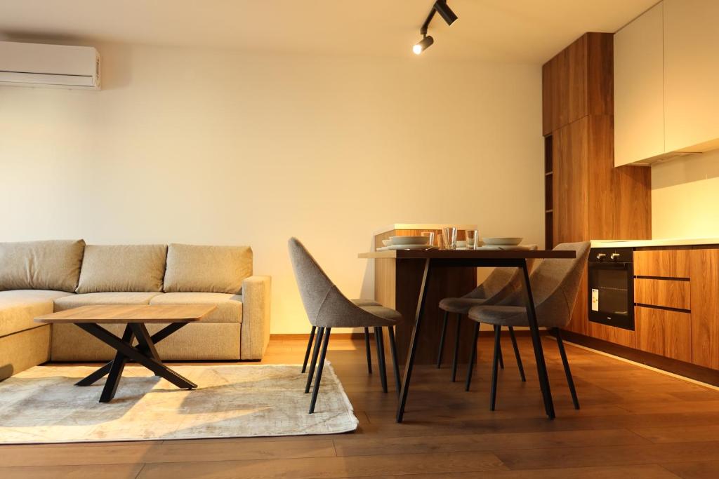 a living room with a couch and a table at NUMA LIVING - Executive Suite in Kumanovo