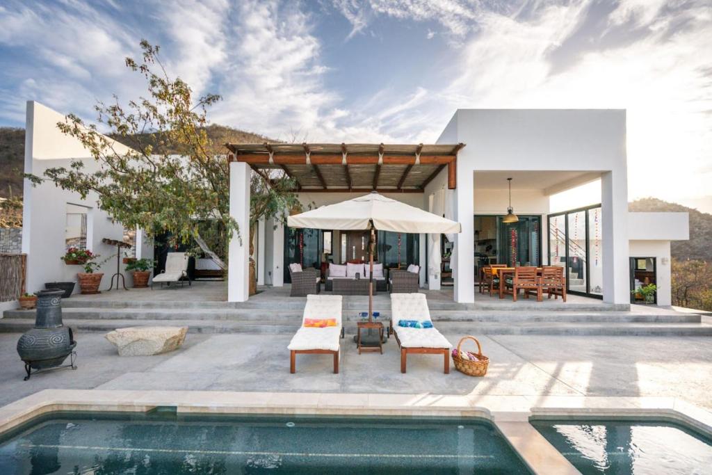 a house with a swimming pool and a patio at Montebello Pool House-3 BD in Los Barriles