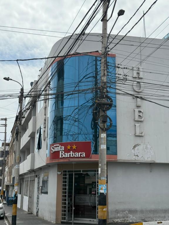 a building with a sign on the side of it at HOTEL SANTA BARBARA PUERTO ilo in Ilo