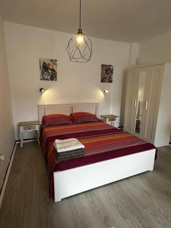 a bedroom with a large bed with a red blanket at Modern & Comfortable Apartment in Tenerife South in Guargacho