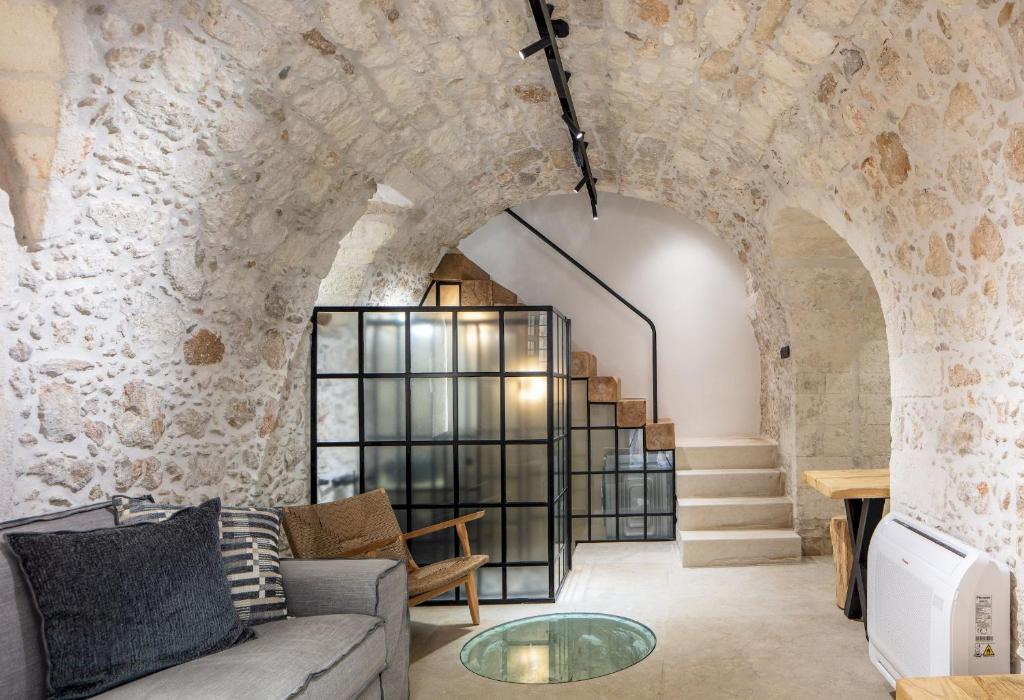 a living room with a couch and a glass table at Margianna's Cupola Luxury Residence in Rethymno