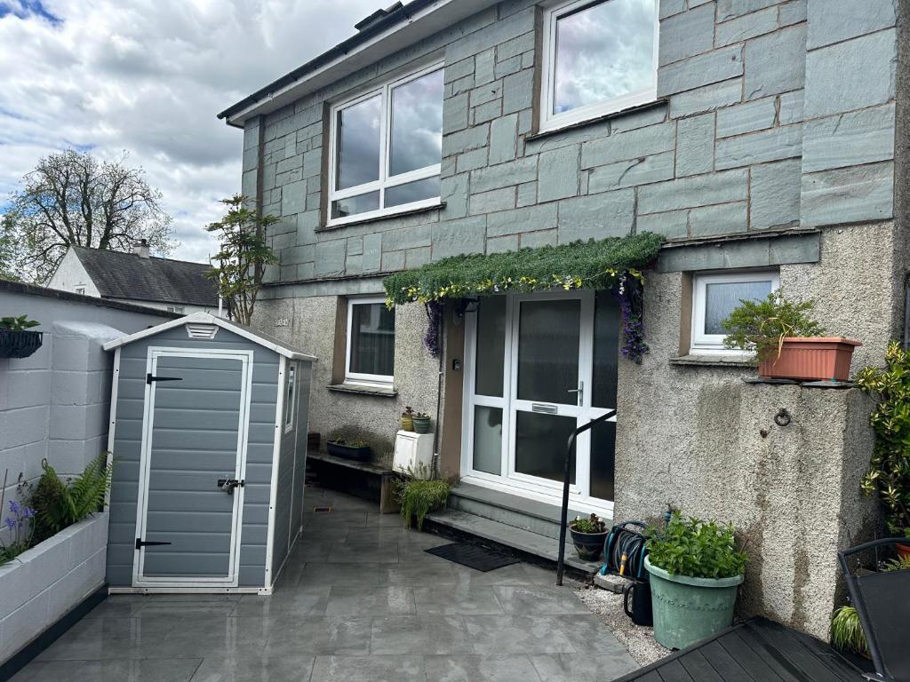 a house with a grey door and a patio at Jakanori in Staveley