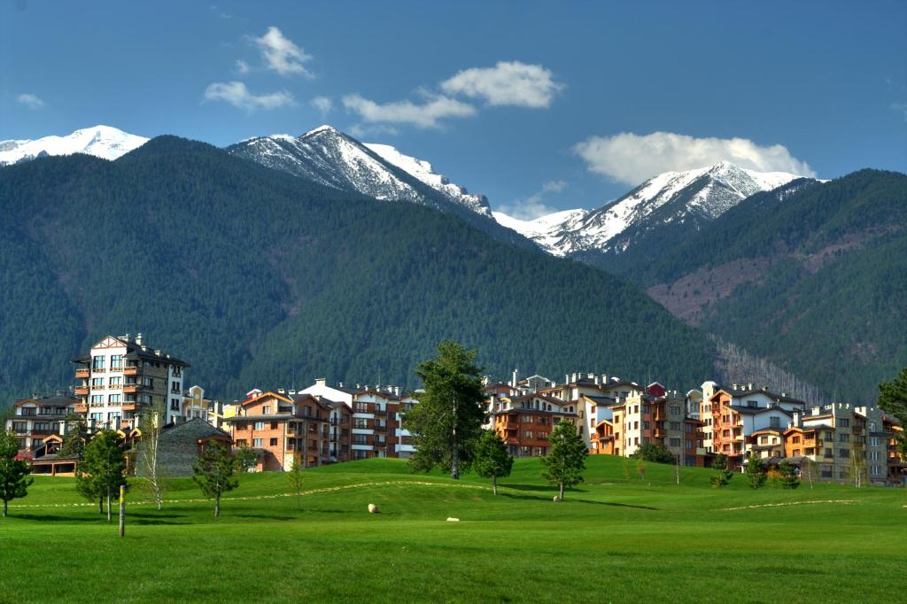 a town in the mountains with snow covered mountains at Villa Nataly at Golf Resort in Bansko