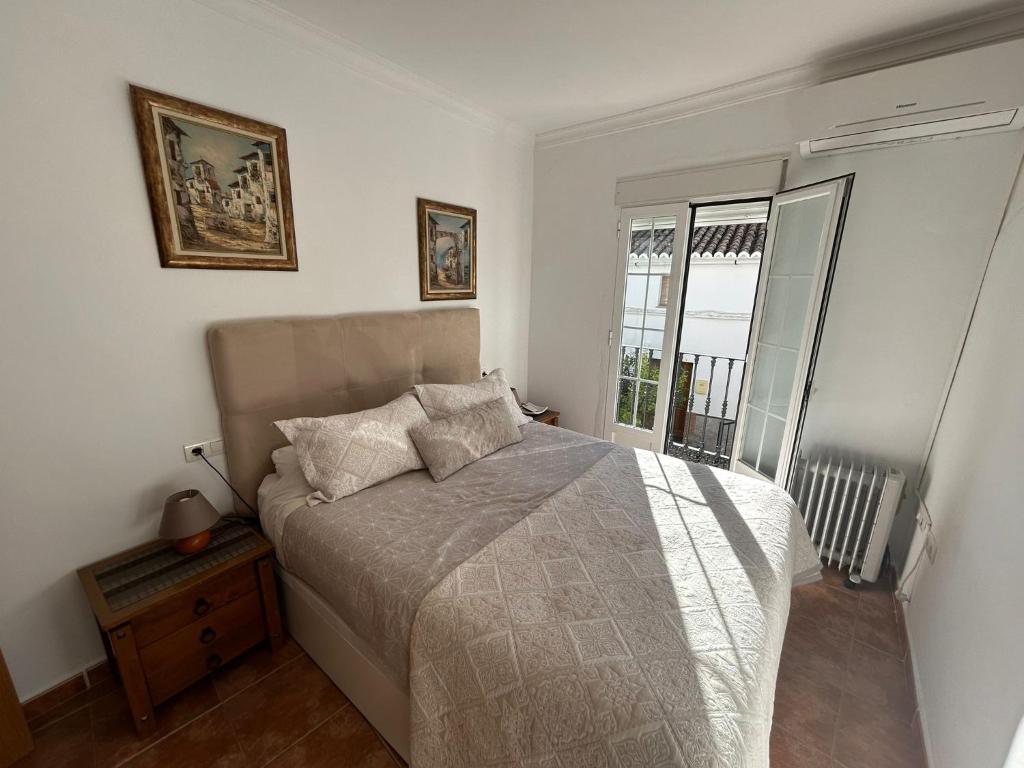 a bedroom with a bed and a window at Casita Maite in Ardales