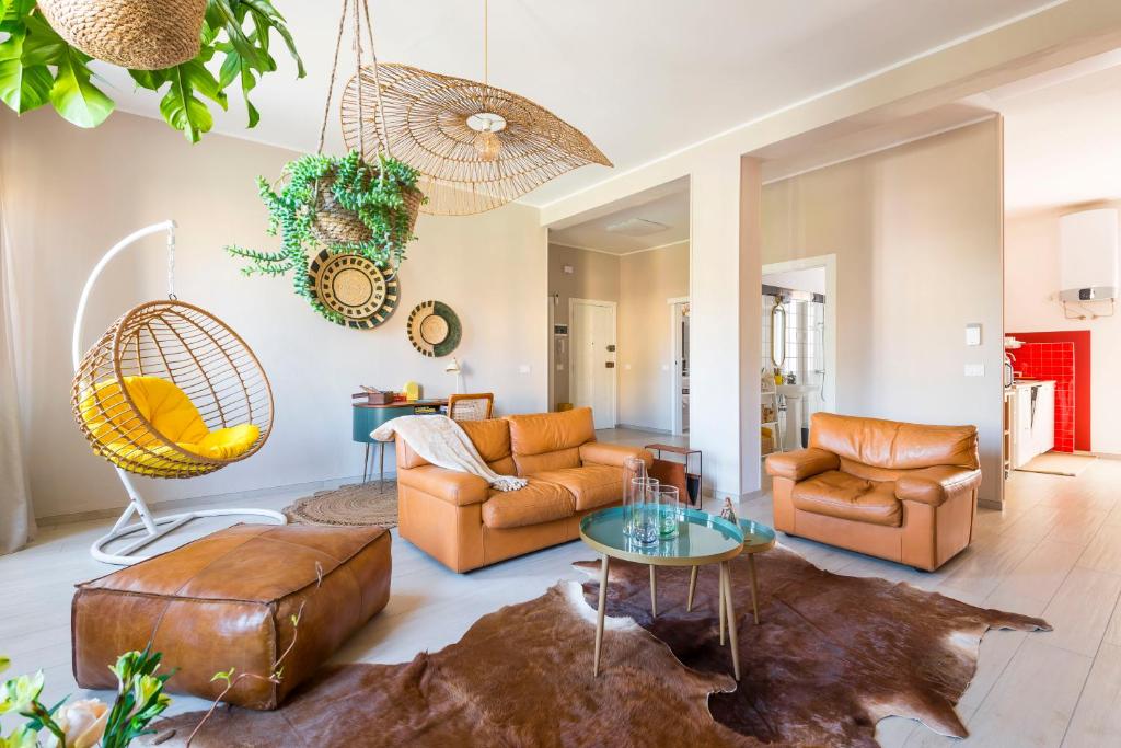a living room with two couches and a table at Henry's House Parma in Parma