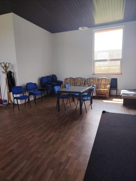 a room with a table and chairs and a window at Hostel Drahonice in Drahonice