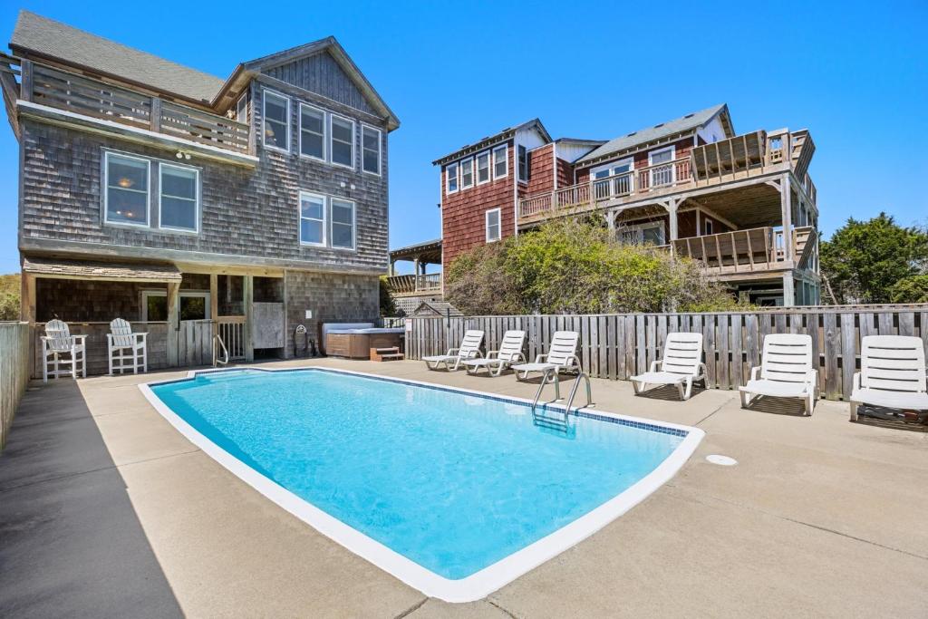 a swimming pool in front of a house at 6107 - No Wake Zone in Nags Head