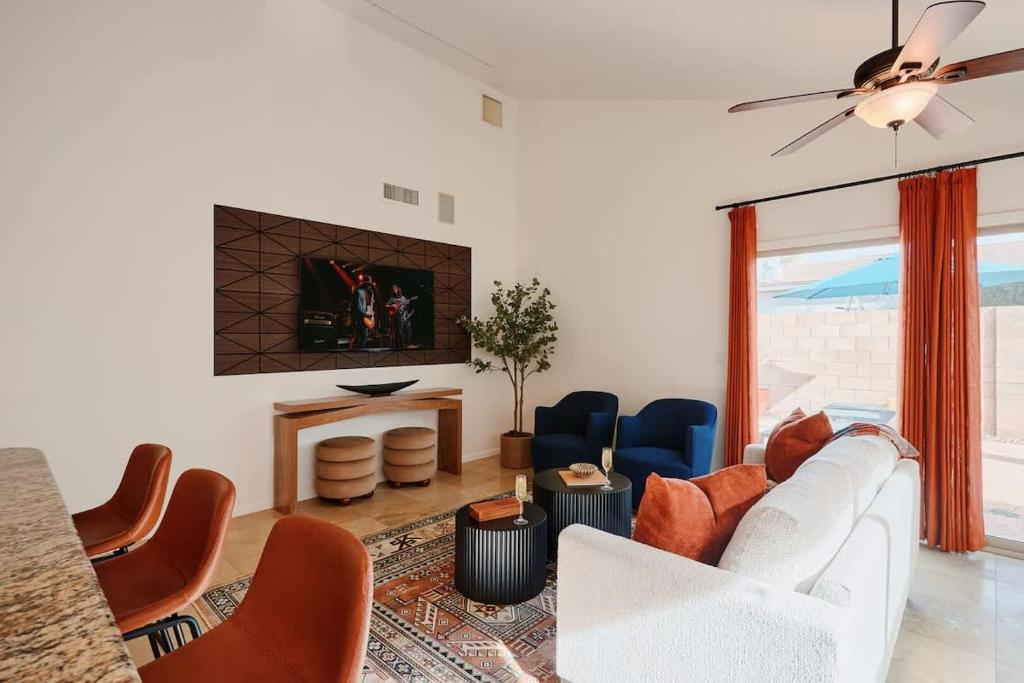 a living room with a white couch and chairs at Cactus Spur - Pool & Fire Pit - Mins to Old Town in Scottsdale
