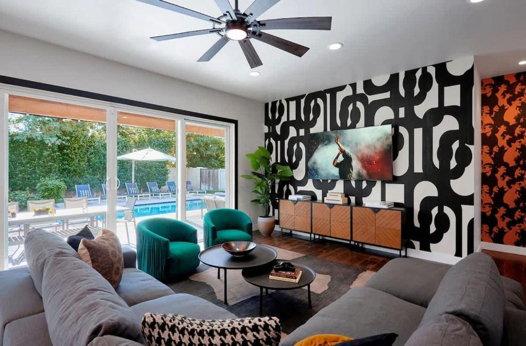 a living room with a couch and a ceiling fan at Contour - Sparkling Pool - Mins to Phoenician Golf in Phoenix