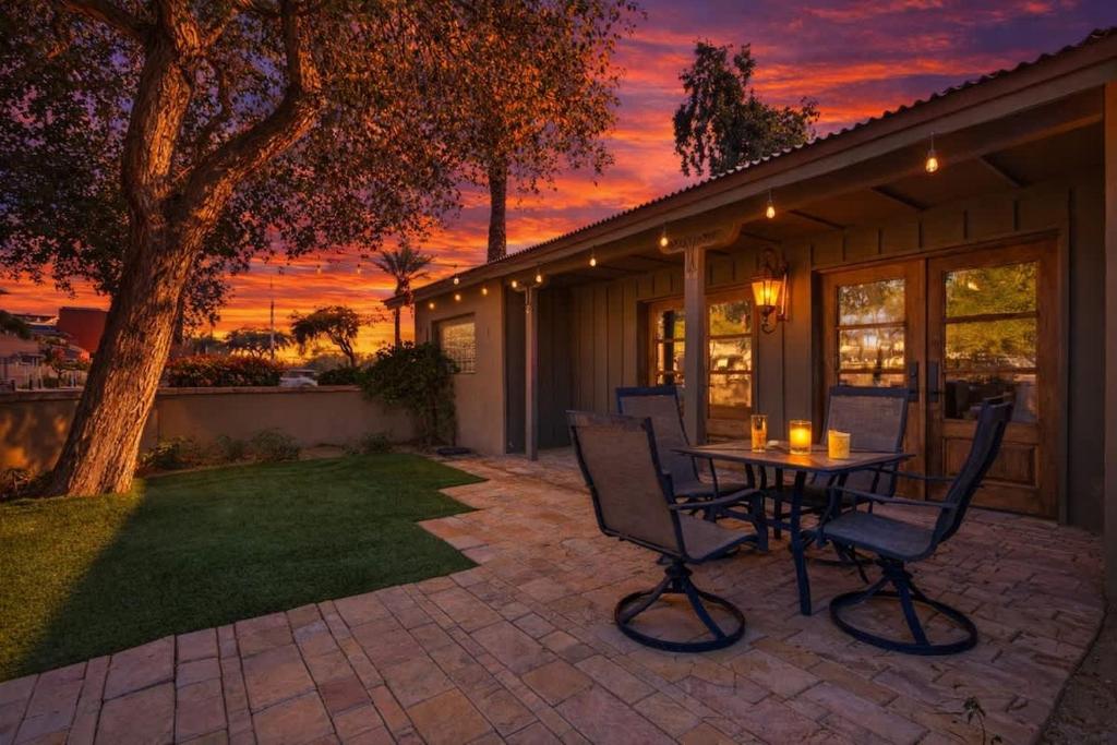 a patio with a table and chairs at sunset at Rhone - In Old Town - Walk to Fashion Square in Scottsdale