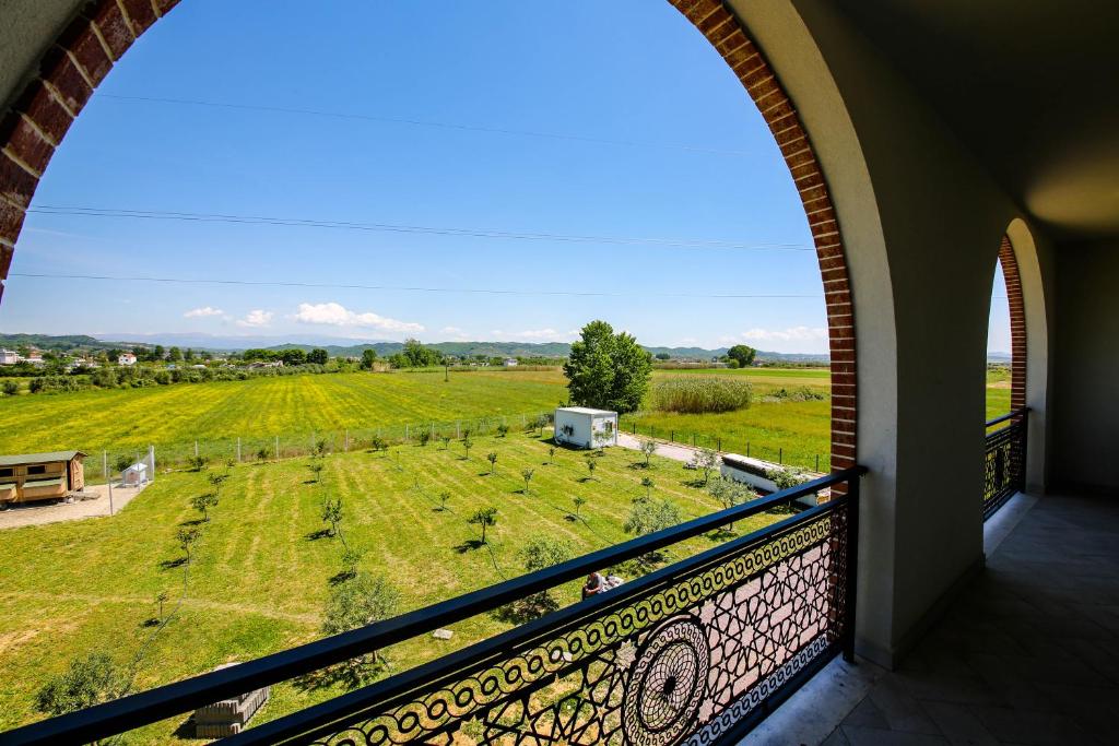 a view from a balcony looking out at a field at Olive Farmhouse in Hamallë