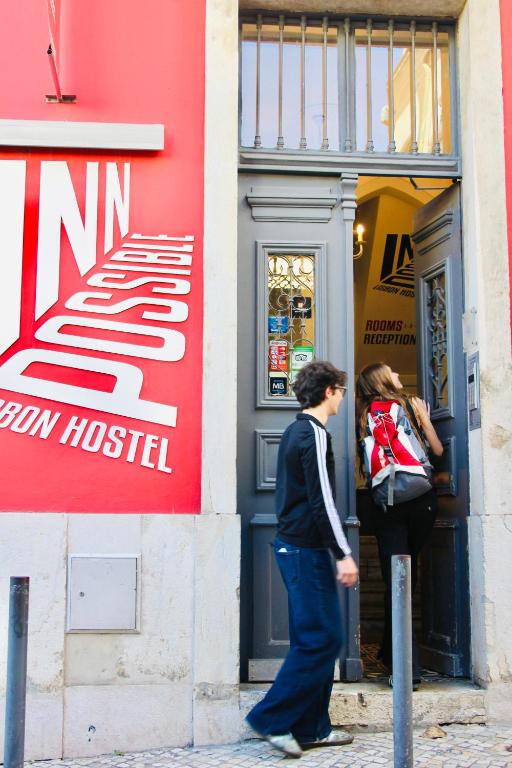 a man and a woman standing in front of a store at Inn Possible Lisbon Hostel in Lisbon