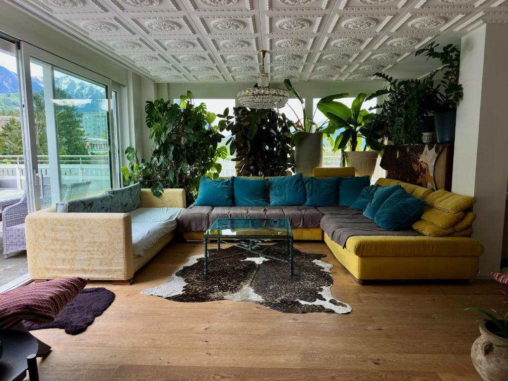 a living room with a couch and some plants at Penthouse in Schaan in Schaan