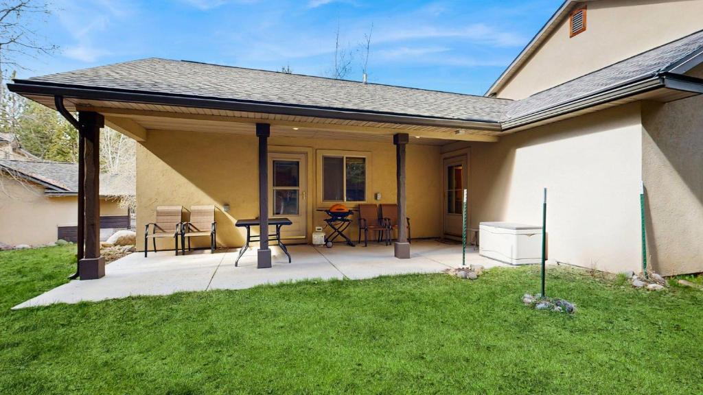 a covered patio with a table in a house at Payette Pines Hideaway in McCall
