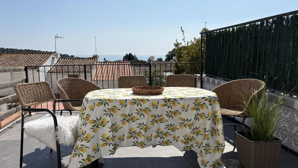 a table with a yellow and white table cloth at la Casa de Flores in Tossa de Mar