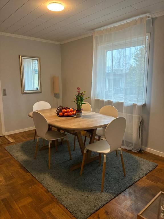 a dining room with a wooden table and chairs at Hus in Risskov