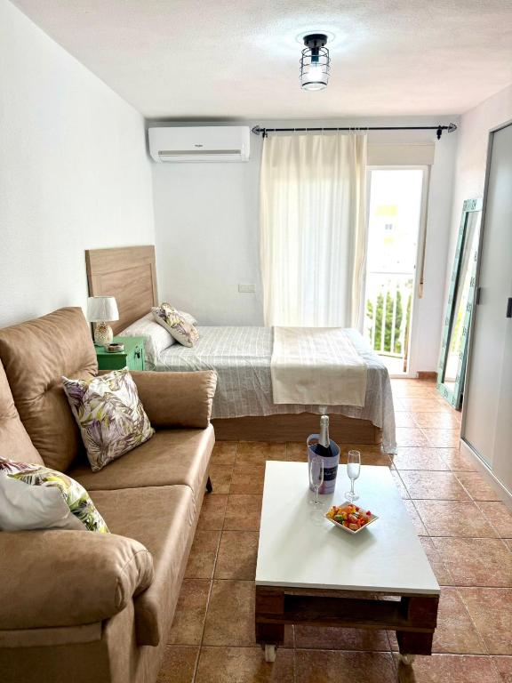 a living room with a couch and a bed at Luis Vives in Benalmádena
