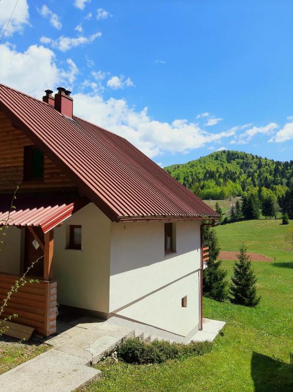 a garage with a red roof on a house at Holiday Home Brist in Brestova Draga