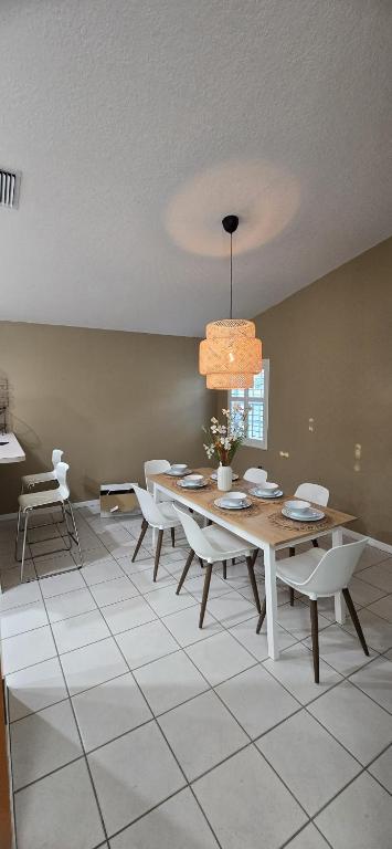 a dining room with a table and chairs at Across from Sawgrass Mall- Next to Amerant Bank Arena in Sunrise
