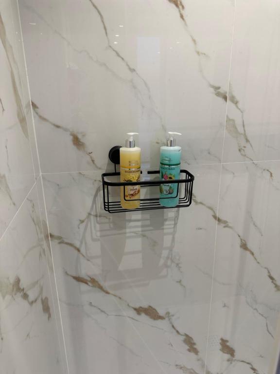 two candles are sitting on a shelf in a bathroom at DOMUS Puteoli in Pozzuoli
