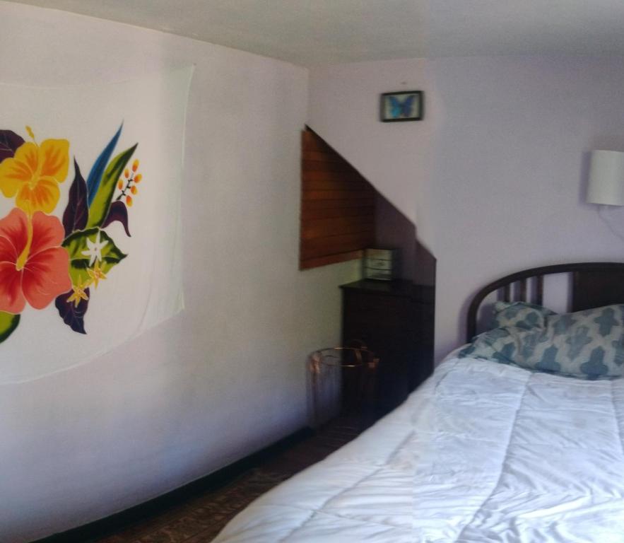 a bedroom with a bed with a flower mural on the wall at Magical stone cottage in Pine Grove Mills