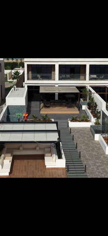 a view of a building with benches and a building at منتجع شاطئ الدانة Hus Chalet in Dammam