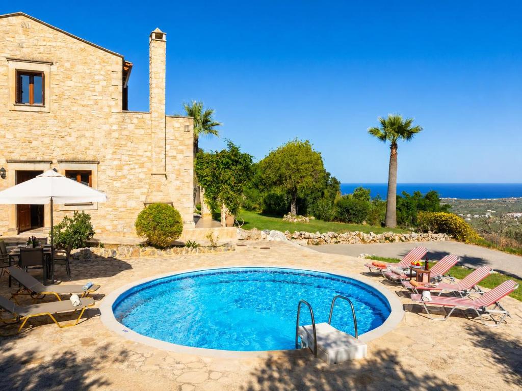 an external view of a villa with a swimming pool at Villa Top Hill in Agia Triada
