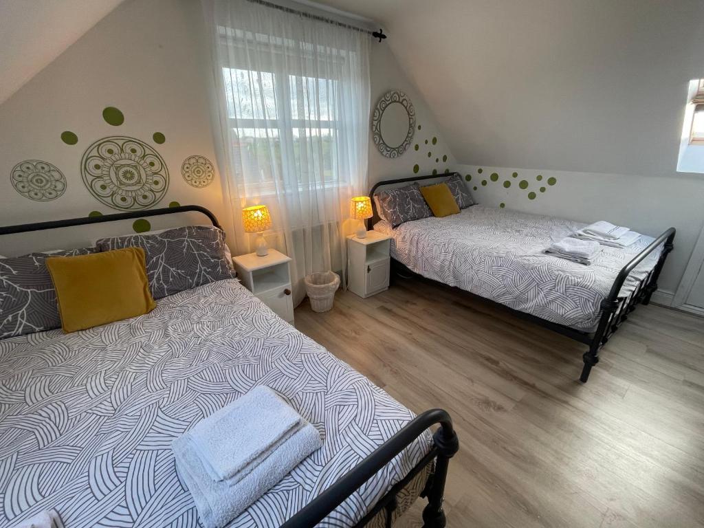 a bedroom with two beds and a window at Wild Atlantic View in Walshestown