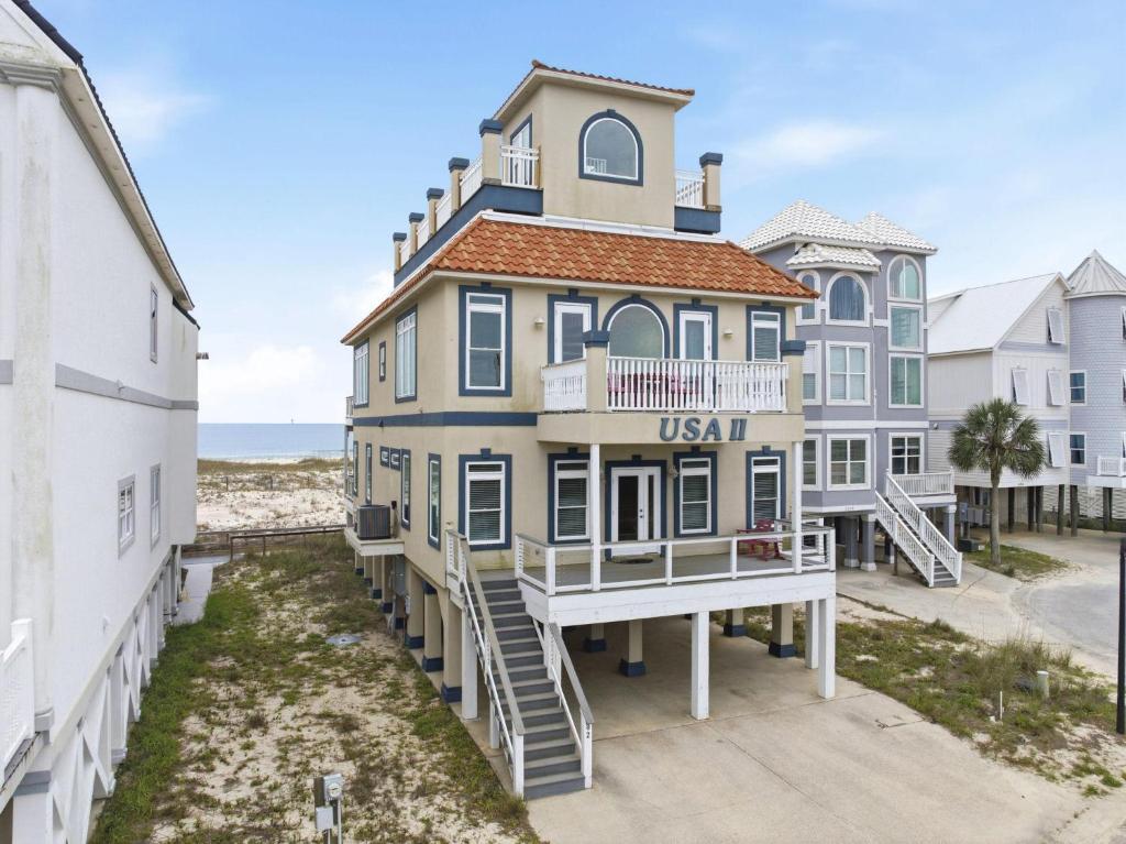 a large house on the beach next to other buildings at USA II in Gulf Shores