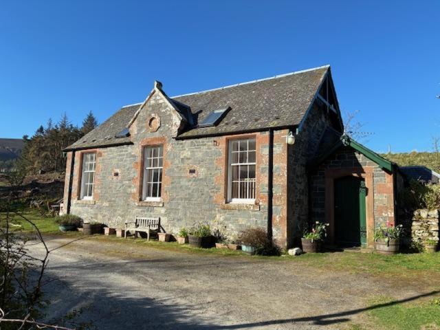 an old brick house with a bench in front of it at 2 Bed in Biggar oc-ca366 in Biggar