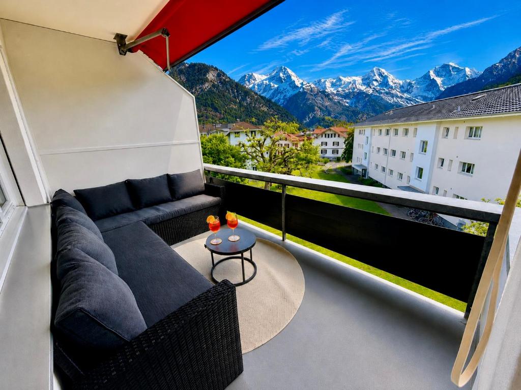 a balcony with a couch and a view of mountains at Topview 2BR Balcony & Mountain View Interlaken in Unterseen