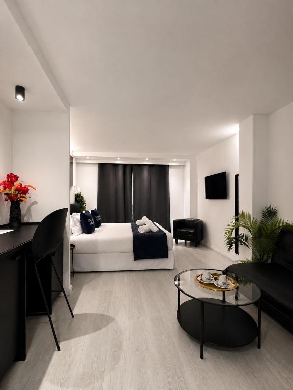 a bedroom with a bed and a living room at Urban Spaces Ibiza in Ibiza Town