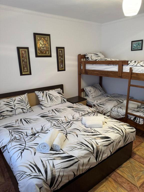 a bedroom with a bed with two bunk beds at Guest House Ajasllari in Çorovodë