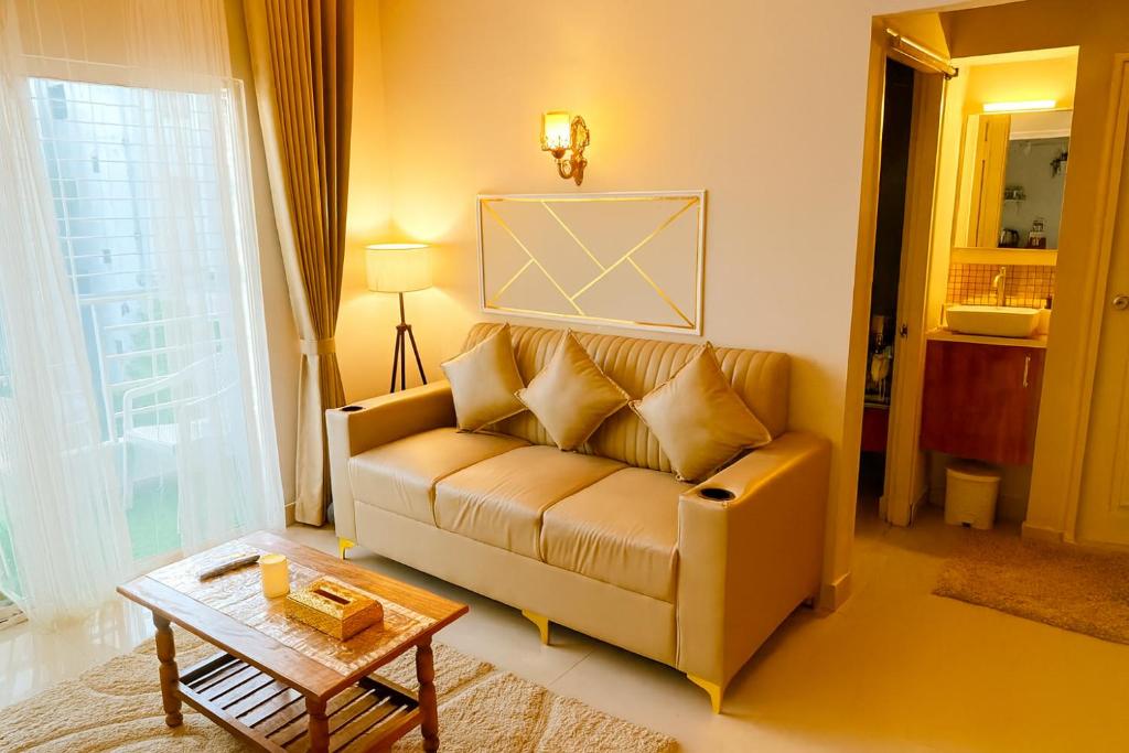 a living room with a couch and a table at NK Luxe Apartments - Full Furnished 2BHKs, Free Wifi, Smart TV, Central Location in Hyderabad