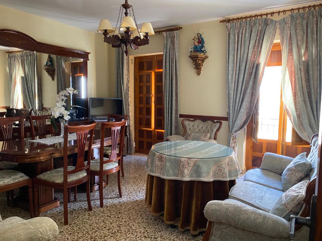a living room with a table and a dining room at Casa Magdalena in Archidona