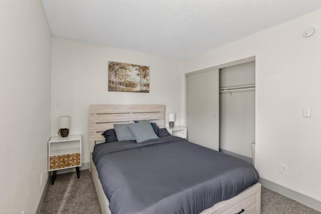 a bedroom with a large bed and a closet at Contemporary 2BR apartment with workspace in Lenexa