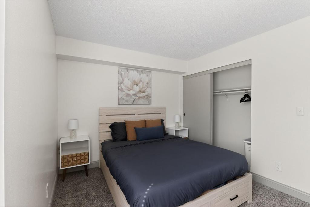 a bedroom with a bed in a white room at Spacious 2BR stay with updated interiors in Lenexa