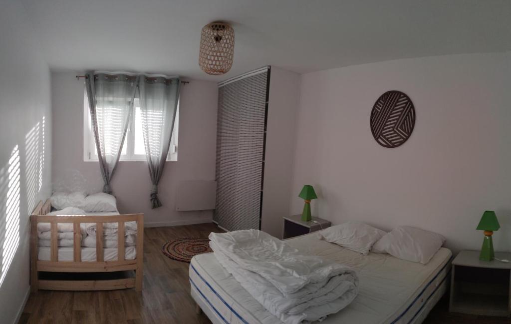 a bedroom with a bed and a chair in it at Appartement Saint Sulpice la Pointe in Saint-Sulpice