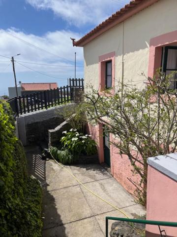 an outside view of a house with a fence at Casa Jardim 21 in Prazeres