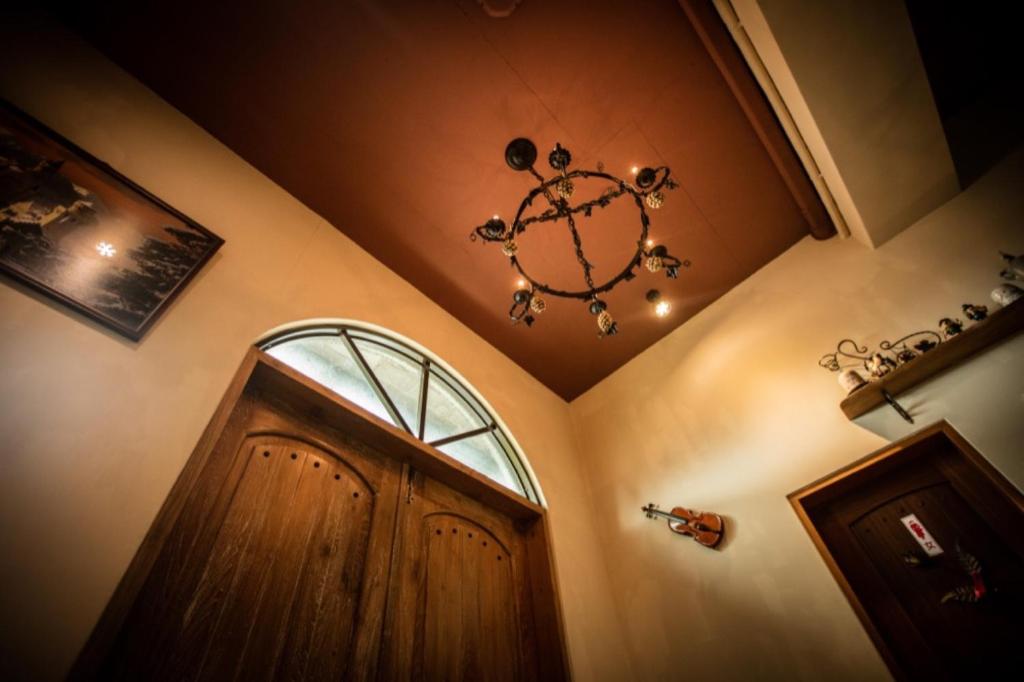 a room with a door and a chandelier at Zum Adler Castle B&amp;B in Jiaoxi