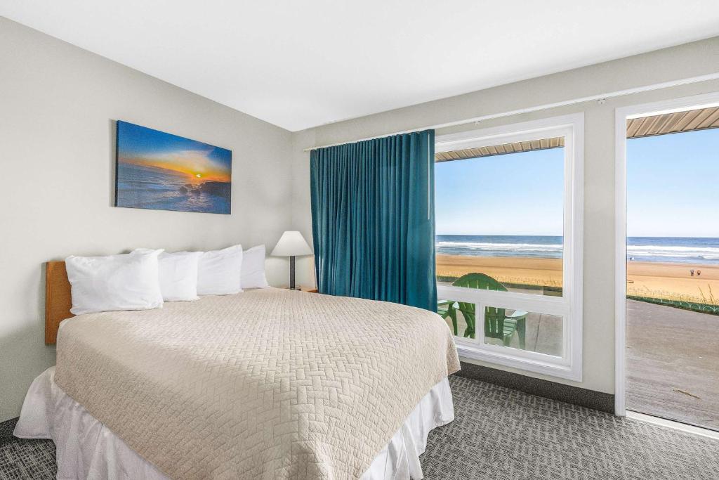 a bedroom with a bed and a large window at Ocean view studio no stairs-Full Kitchen Patio in Lincoln City