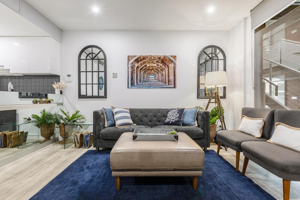 a living room with a couch and a table at The Port Melbourne Experience in Melbourne