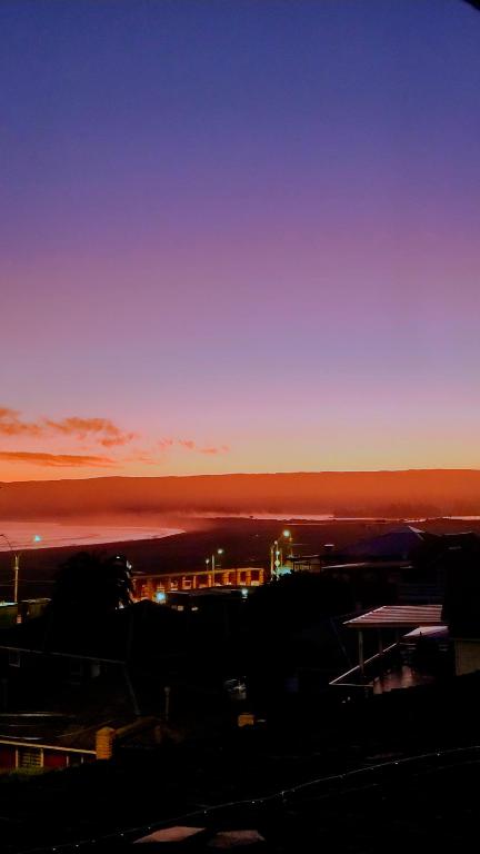 a sunset over the ocean with a train at Paldoa in Pichilemu